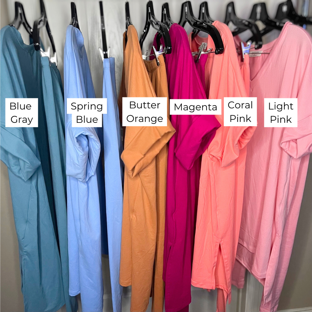 Different colored shirts and leggings hanging on clothes rack
