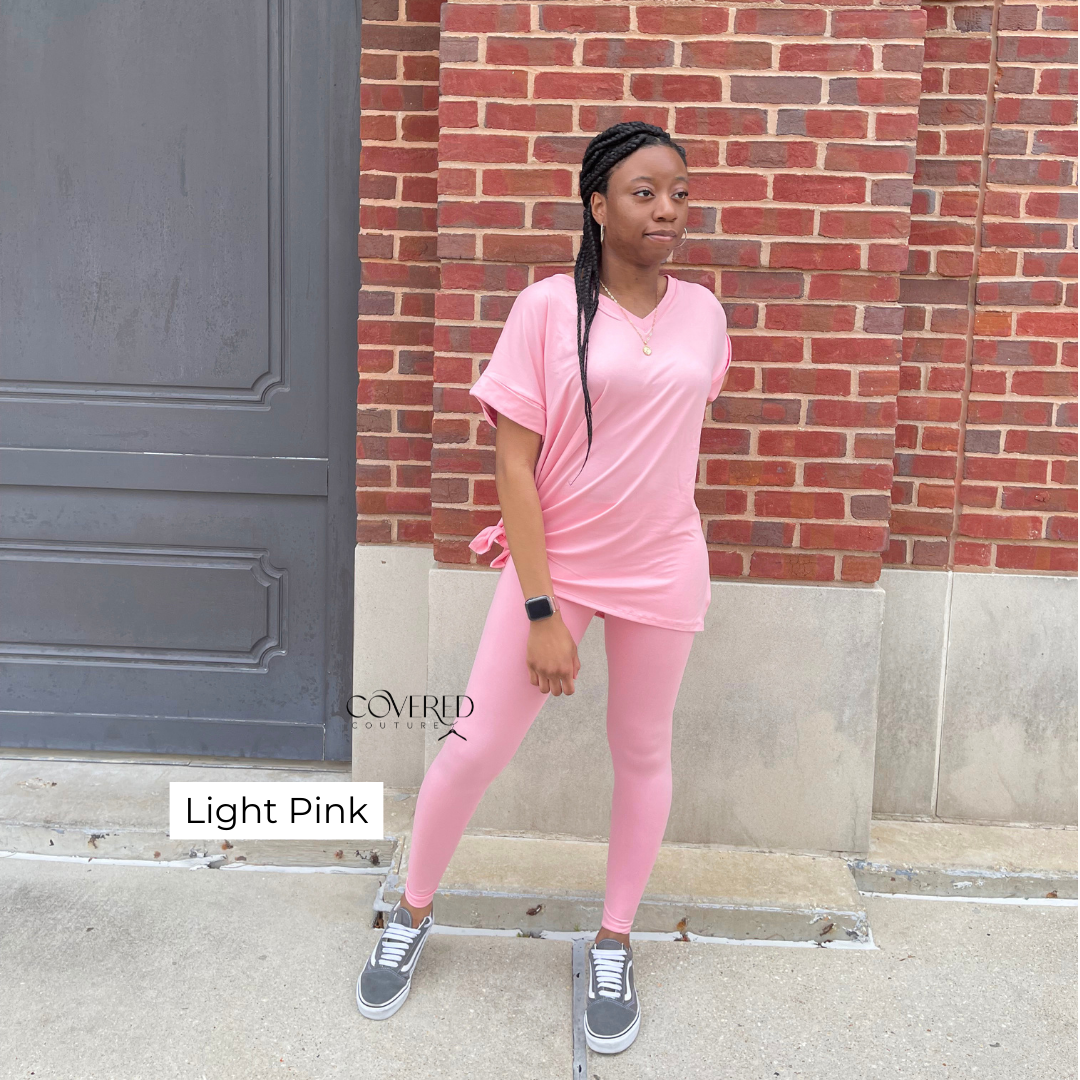 Light pink polyester and spandex oversized top and matching leggings set with gray vans shoes