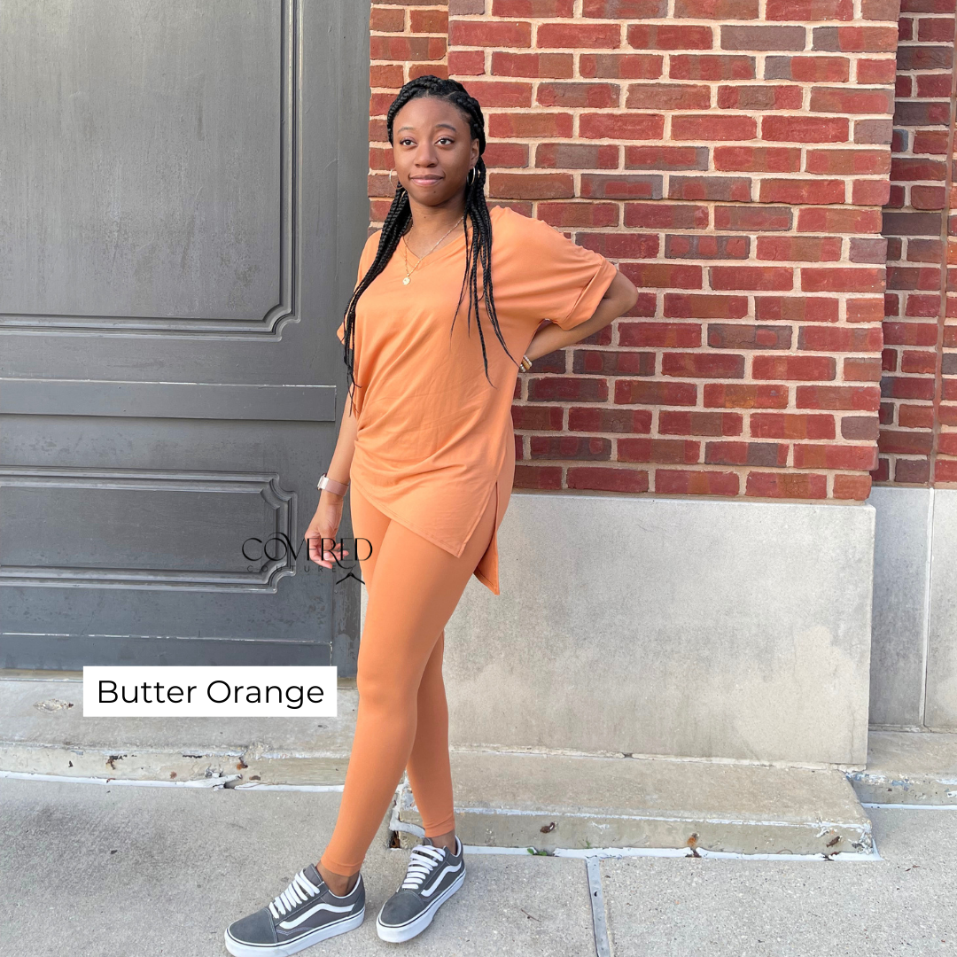 Butter / soft orange polyester and spandex oversized top and matching leggings set with gray vans shoes
